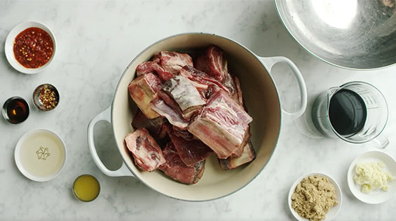 Place ribs and ingredients in Dutch oven.