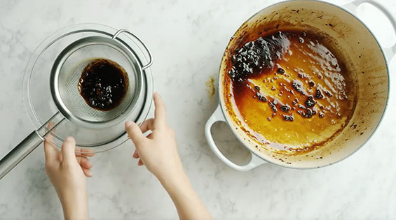 Strain the liquid through a fine-meshed sieve and discard the solids.